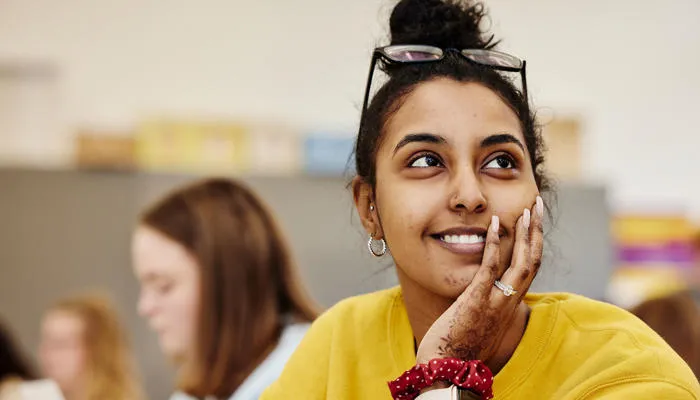 A student smiles in class.